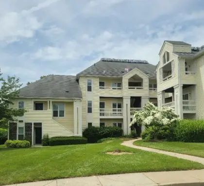 Commercial Roofing Contractor Rockville MD Asphalt shingle roofing on yellow three-story apartment buildings