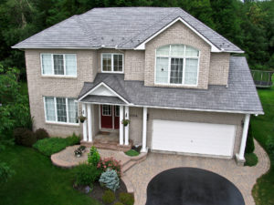 Aerial view of two-story suburban home with two-car garage