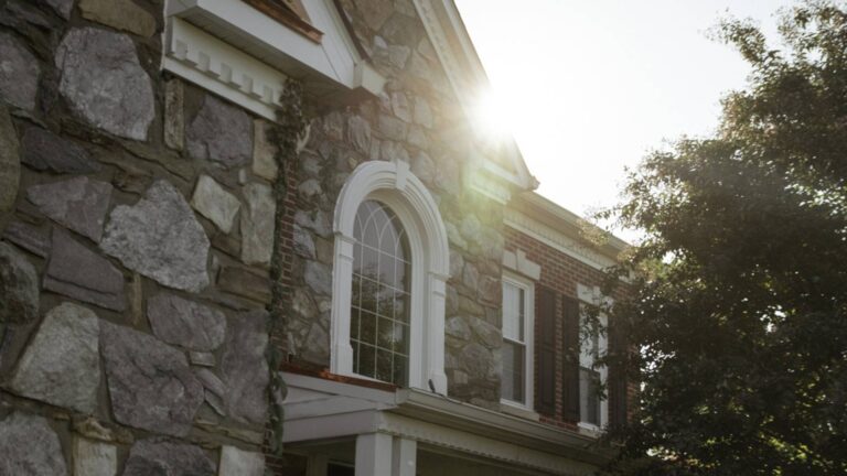 Stone home in Maryland with white windows and trim by Presidential Exteriors
